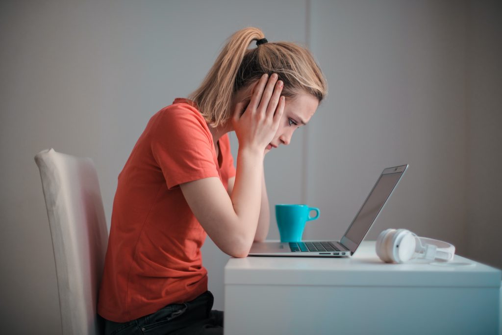 Vrouw kijkt naar laptop.